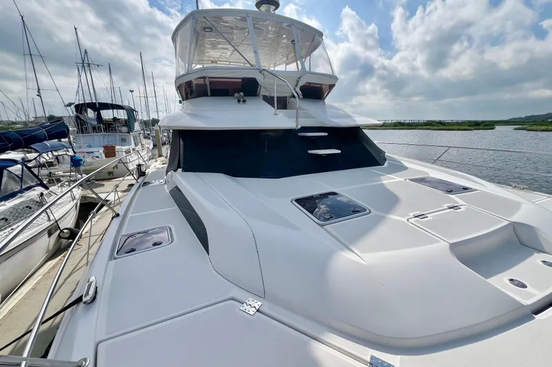 Slide: The Image of Aquila 44 yacht, 2019 model, docked with clear sky and water view. - 6