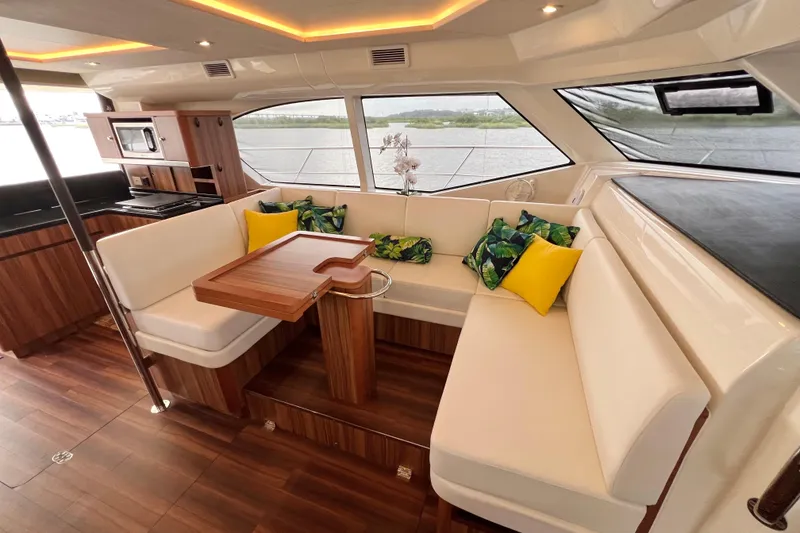 Slide: The Image of Luxurious 2019 Aquila 44 yacht interior with elegant seating and modern kitchen amenities. - 63