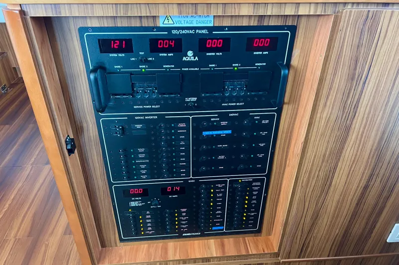 Slide: The Image of Electrical control panel on a 2019 Aquila 44 yacht, featuring voltage and amperage displays. - 64