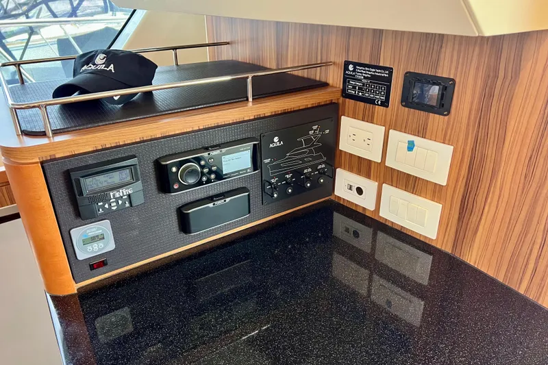 Slide: The Image of Control panel of 2019 Aquila 44 yacht with electronic devices and switches. - 65