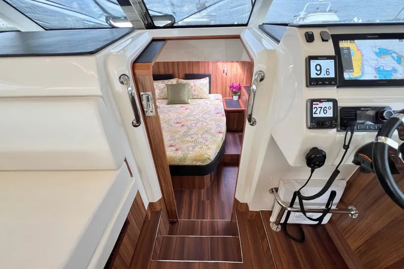 Slide: The Image of Luxurious 2019 Aquila 44 yacht interior with modern helm, seating, and elegant wood finishes. - 68