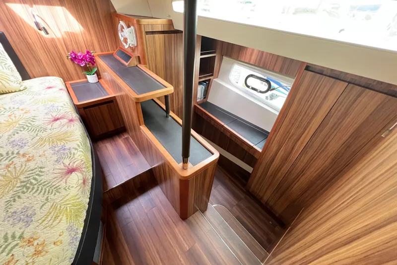 Slide: The Image of Luxurious bedroom interior of 2019 Aquila 44 yacht with floral bedding and wood paneling. - 72