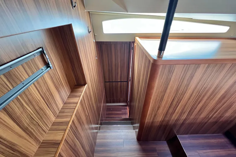 Slide: The Image of Luxurious 2019 Aquila 44 yacht cabin with wood finish and floral bedding. - 77