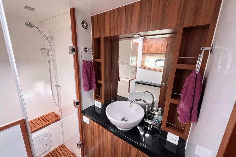 Slide: The Image of Luxurious 2019 Aquila 44 yacht bathroom with modern fixtures and wood accents. - 79