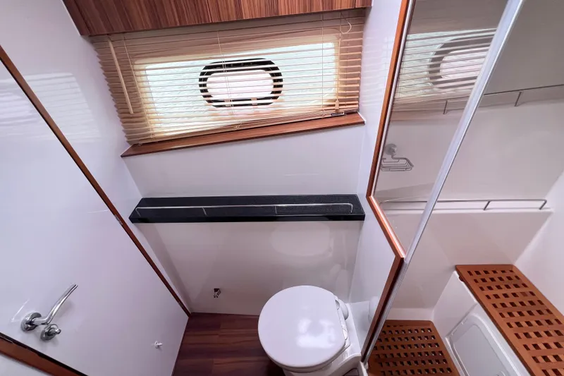Slide: The Image of Luxurious bathroom in 2019 Aquila 44 yacht with modern fixtures and wooden accents. - 80