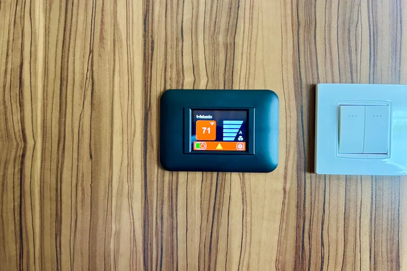 Slide: The Image of Luxurious 2019 Aquila 44 yacht cabin with wood paneling and cozy bedding. - 85