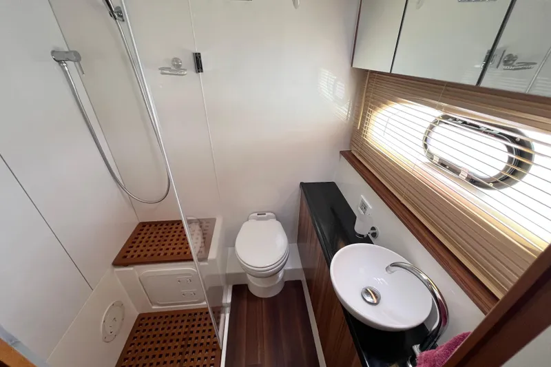 Slide: The Image of Interior of 2019 Aquila 44 yacht showing bathroom and wooden paneling. - 87