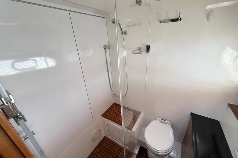 Slide: The Image of Luxurious 2019 Aquila 44 yacht bathroom with shower, toilet, and sink, featuring modern design elements. - 88