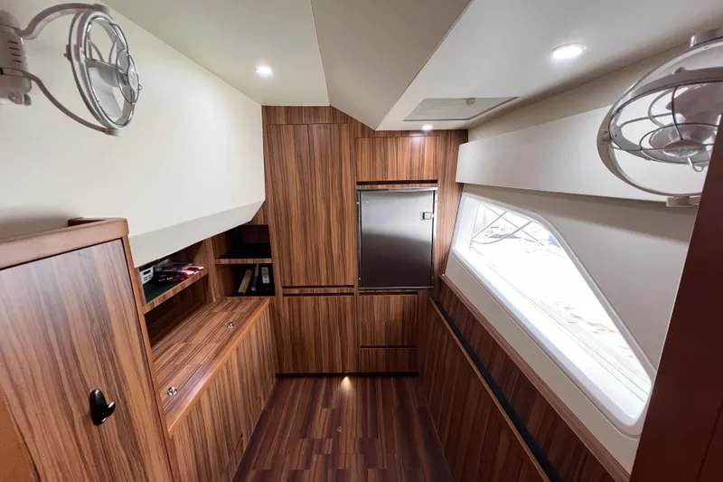 Slide: The Image of Luxurious wood-finished interior of 2019 Aquila 44 yacht, featuring modern cabinetry and lighting. - 93