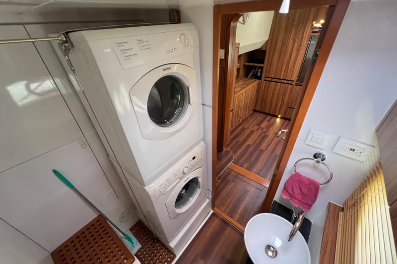 Slide: The Image of Stainless steel door on 2019 Aquila 44 yacht, surrounded by wood paneling. - 97