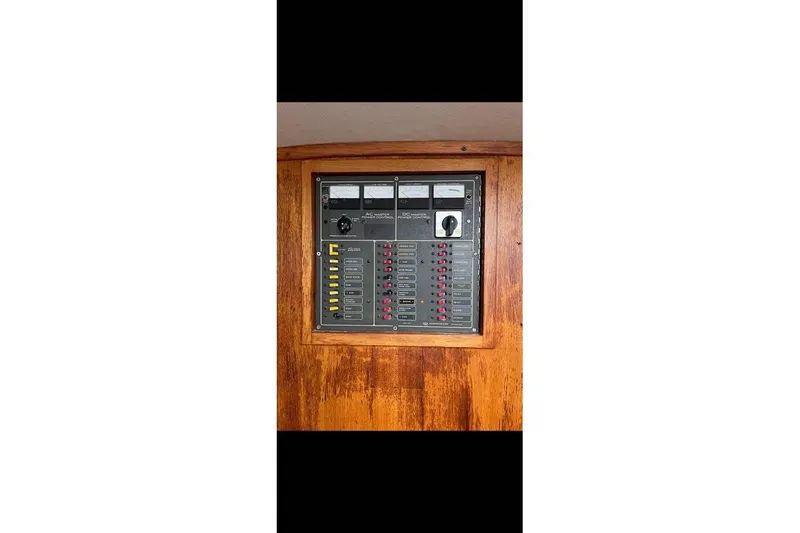Slide: The Image of Electrical panel on 1980 Alden 44 boat, featuring switches and meters. - 10