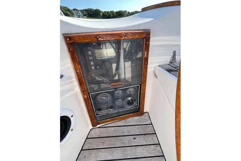 Slide: The Image of Control panel of a 1980 Alden 44 sailboat with wooden trim and gauges. - 16