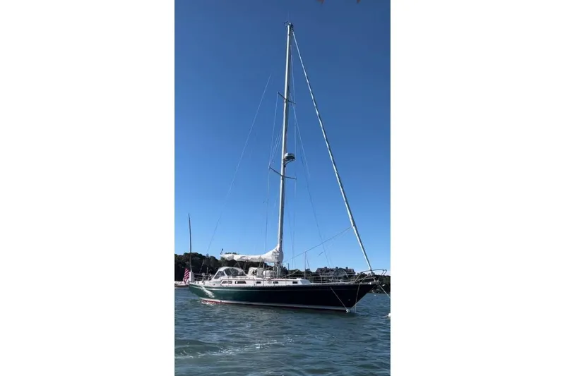 Slide: The Image of 1980 Alden 44 sailboat on calm water under clear blue sky. - 2