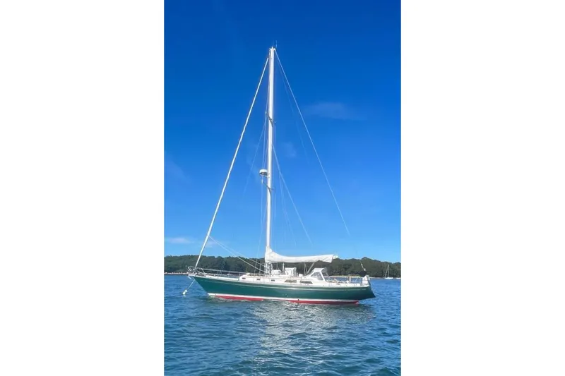 Slide: The Image of 1980 Alden 44 sailboat on calm water under clear blue sky. - 23