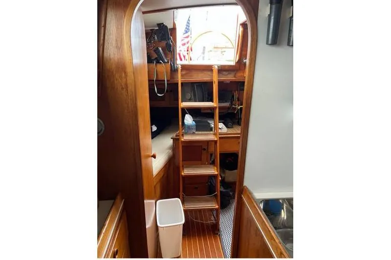 Slide: The Image of Interior of 1980 Alden 44 sailboat with wooden ladder and American flag. - 4