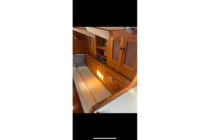 Slide: The Image of Interior of 1980 Alden 44 yacht with wooden cabinetry and cushioned seating. - 6