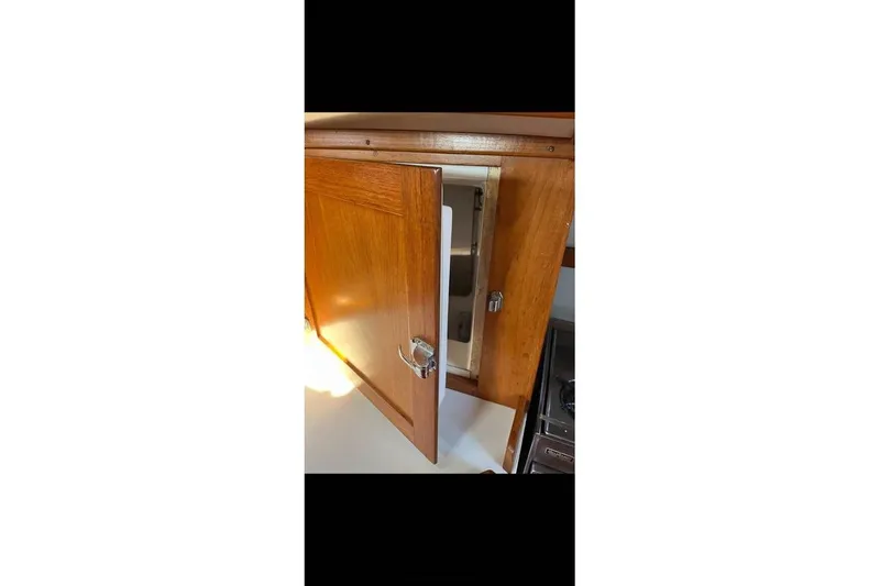 Slide: The Image of Wooden cabinet door open on 1980 Alden 44 yacht interior. - 9