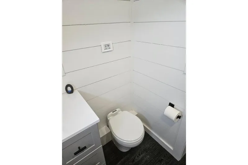 Slide: The Image of Modern bathroom in 2021 East Coast Houseboats Freedom 40, featuring sleek white shiplap walls. - 11