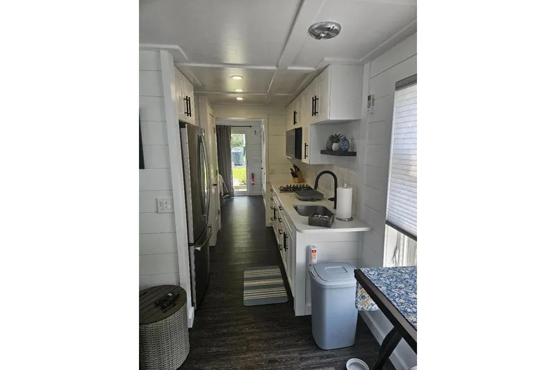 Slide: The Image of Modern kitchen interior of 2021 East Coast Houseboats Freedom 40, featuring sleek appliances and cabinetry. - 16