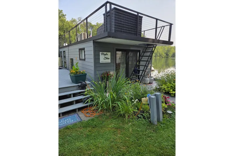 Slide: The Image of Houseboat "Freedom 40" by East Coast Houseboats, 2021, docked with rooftop deck and garden. - 3