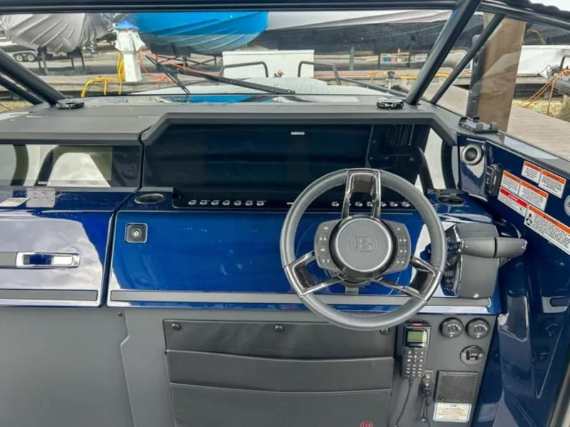 Slide: The Image of 2024 BRABUS Shadow 1000 ST boat dashboard with steering wheel and control panel. - 16