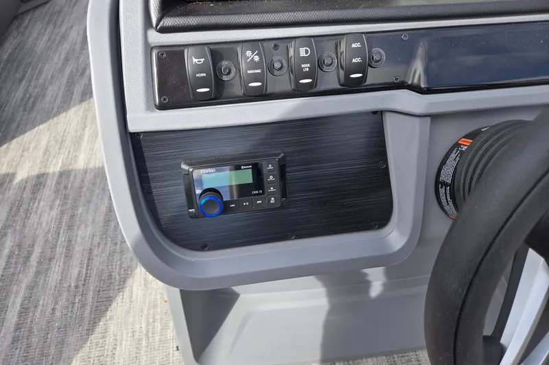 Slide: The Image of Control panel of 2026 Godfrey Sweetwater 2086 C boat with switches and audio system. - 17