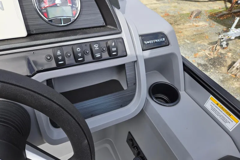 Slide: The Image of 2026 Godfrey Sweetwater 2086 C dashboard with controls and steering wheel. - 18