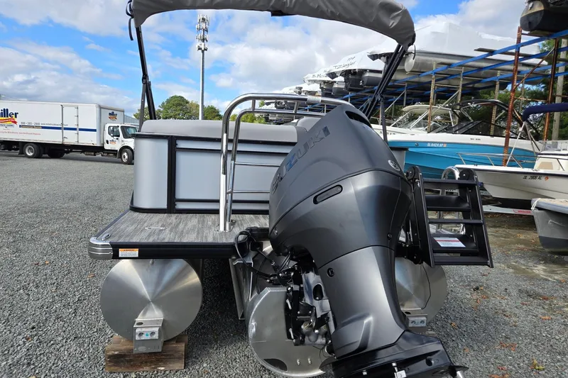 Slide: The Image of 2026 Godfrey Sweetwater 2086 C pontoon boat with Suzuki outboard motor, parked outdoors. - 3
