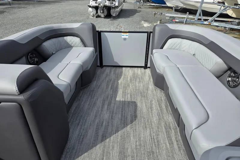 Slide: The Image of 2026 Godfrey Sweetwater 2086 C pontoon boat interior with gray seating and carpet flooring. - 33