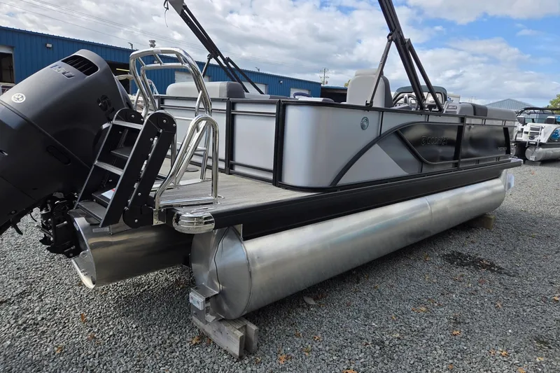 Slide: The Image of 2026 Godfrey Sweetwater 2086 C pontoon boat with outboard motor, parked on gravel. - 4