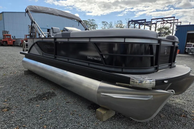 Slide: The Image of 2026 Godfrey Sweetwater 2086 C pontoon boat on gravel lot, under cloudy sky. - 7
