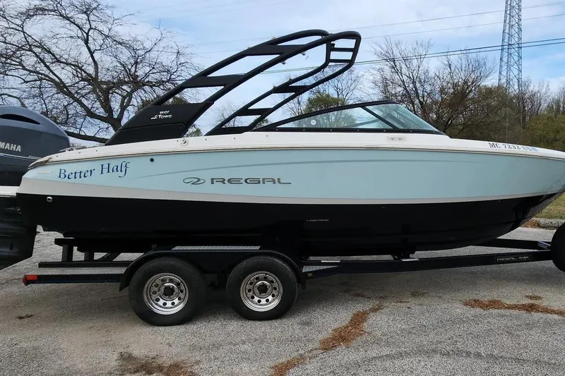 The Image of 2022 Regal LX2 boat named "Better Half" on a trailer, parked outdoors. - 1