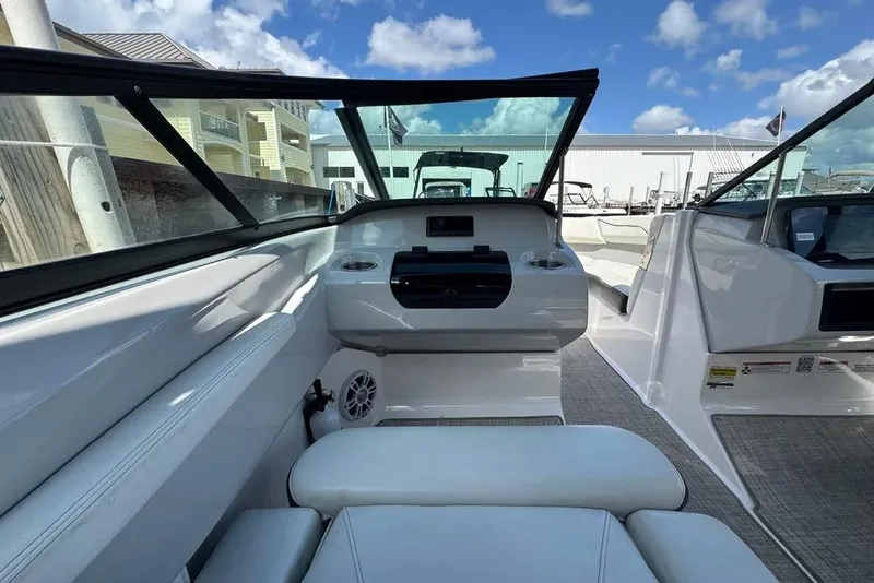 Slide: The Image of Interior view of 2022 Regal LX2 boat with modern seating and dashboard. - 14