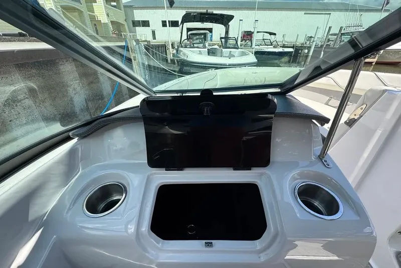 Slide: The Image of 2022 Regal LX2 boat interior with cup holders and storage compartment. - 16