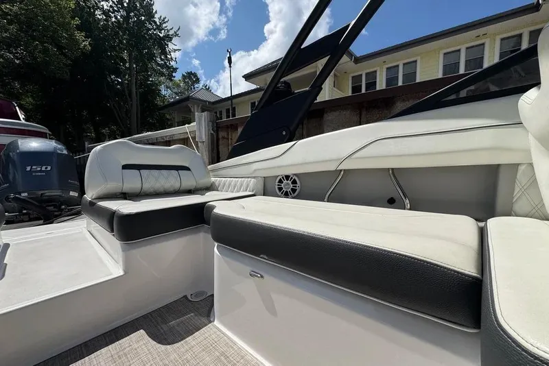 Slide: The Image of 2022 Regal LX2 boat interior with cushioned seating and Yamaha outboard motor. - 18