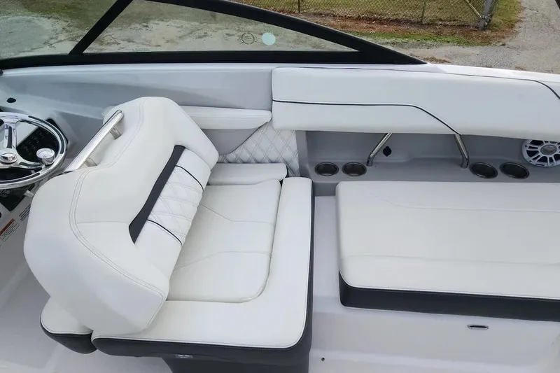 Slide: The Image of 2022 Regal LX2 boat interior with white leather seating and modern steering wheel. - 21