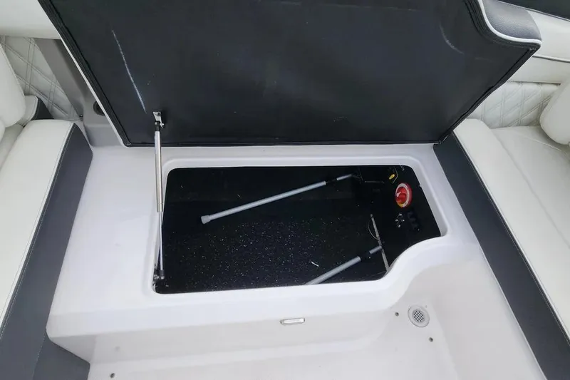 Slide: The Image of 2022 Regal LX2 boat storage compartment with open lid, showcasing interior details. - 24