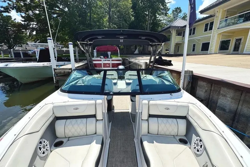 Slide: The Image of 2022 Regal LX2 boat docked, featuring luxurious seating and sleek design. - 26