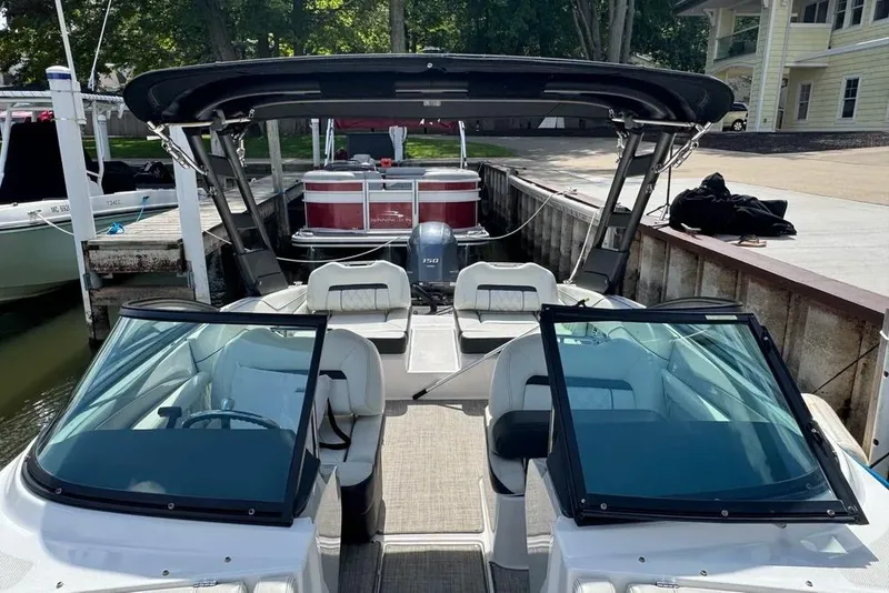 Slide: The Image of 2022 Regal LX2 boat docked, featuring sleek design and spacious seating. - 3