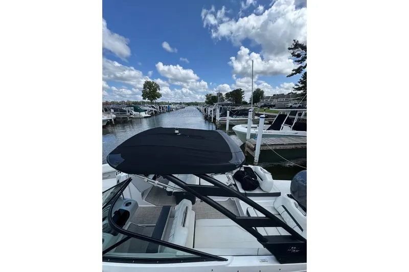Slide: The Image of 2022 Regal LX2 boat docked at a marina under a clear blue sky. - 30