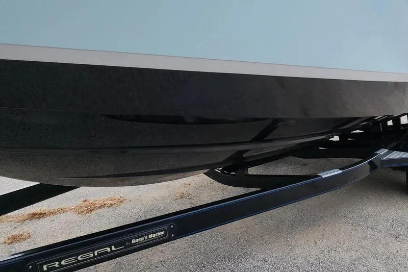 Slide: The Image of 2022 Regal LX2 boat hull on trailer, showcasing sleek design and craftsmanship. - 35
