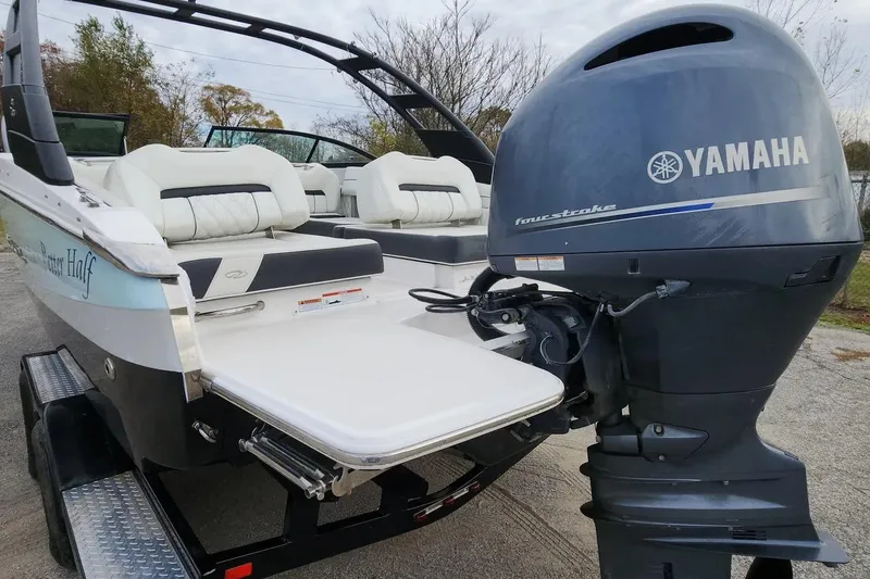 Slide: The Image of 2022 Regal LX2 boat with Yamaha four-stroke engine, featuring luxurious seating. - 36