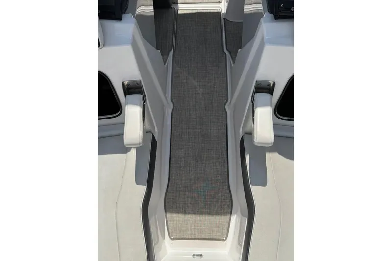 Slide: The Image of 2022 Regal LX2 boat interior with gray flooring and white seating. - 39