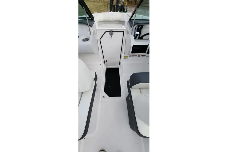 Slide: The Image of 2022 Regal LX2 boat interior with white seating and storage compartment. - 47