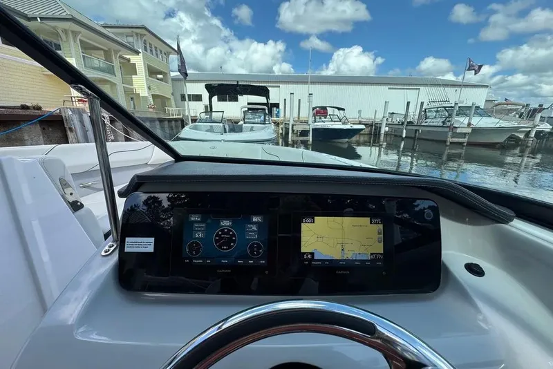 Slide: The Image of 2022 Regal LX2 boat dashboard with navigation display at marina. - 7