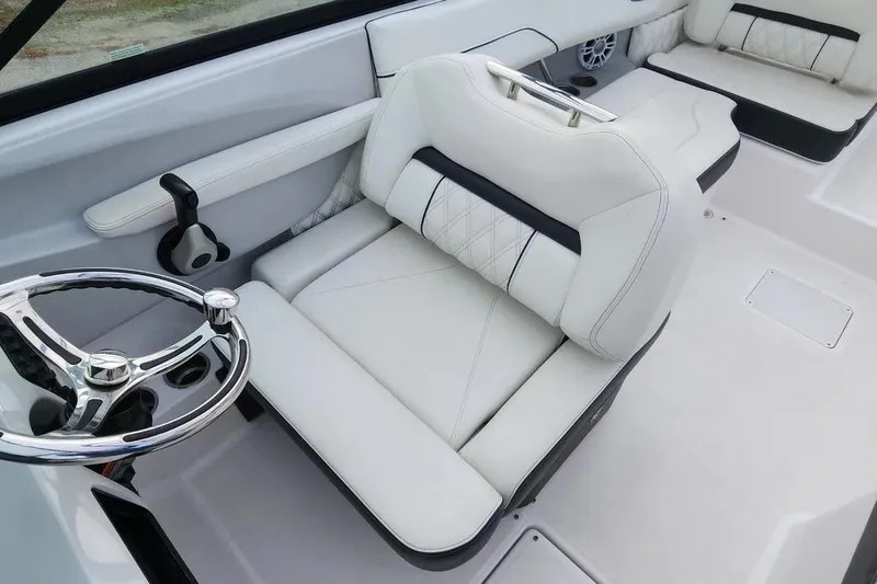 Slide: The Image of 2022 Regal LX2 boat interior with white leather seating and chrome steering wheel. - 8