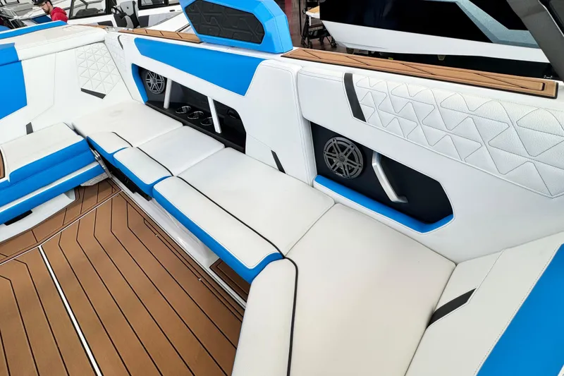 Slide: The Image of 2026 Nautique Super Air Nautique GS22 interior with blue and white seating, wood accents. - 10