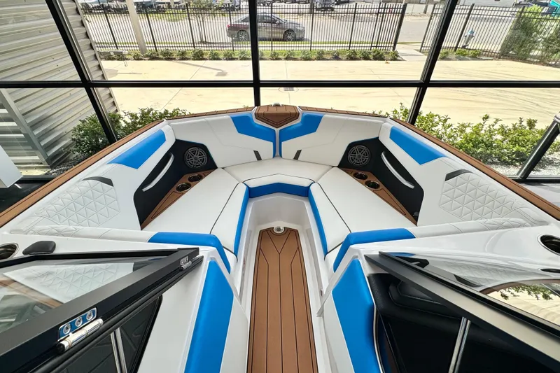 Slide: The Image of 2026 Nautique Super Air Nautique GS22 interior with blue and white seating, wood accents. - 4