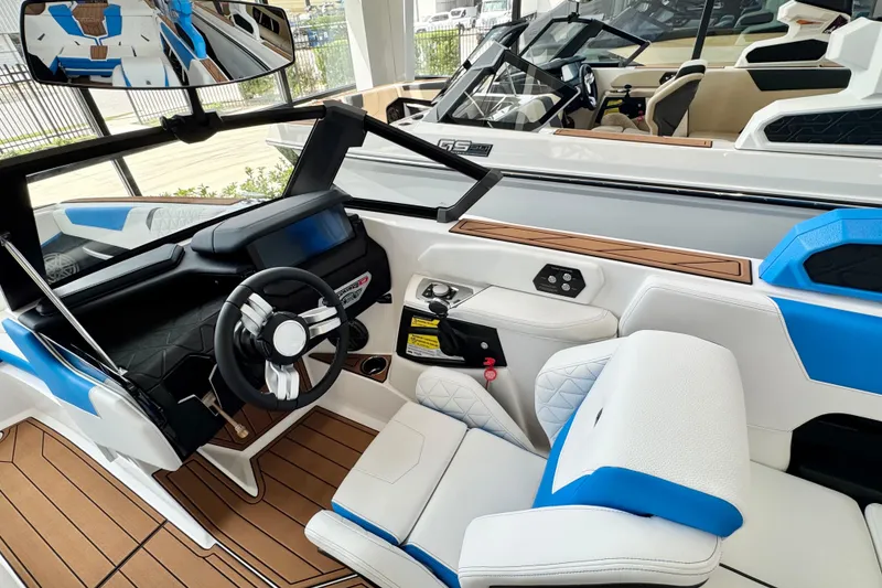 Slide: The Image of 2026 Nautique Super Air Nautique GS22 interior with modern dashboard and blue-white seating. - 8