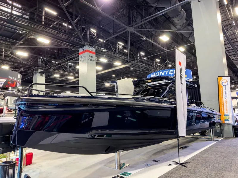 Slide: The Image of 2023 BRABUS Shadow 900 ST luxury boat displayed at an indoor exhibition. - 14